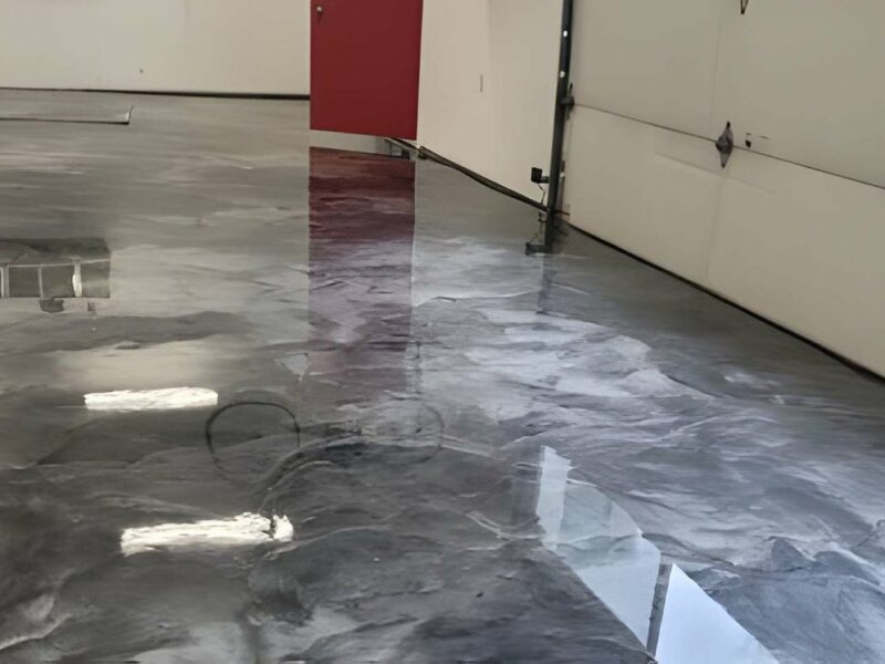 High-gloss metallic silver and charcoal epoxy garage floor coating with reflective finish